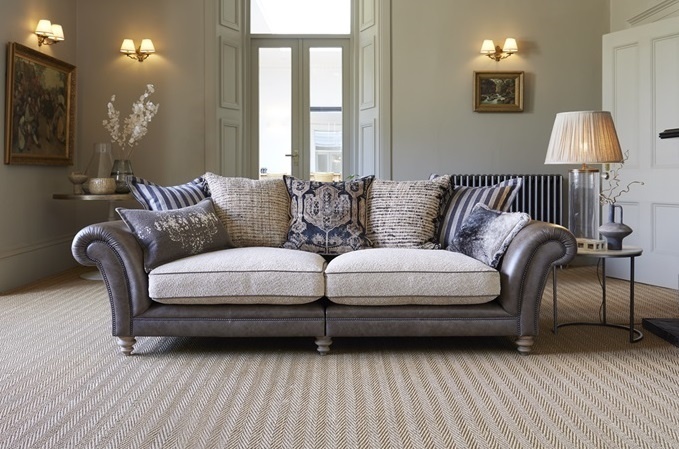 Fabric and leather sofa with patterned cushions in a classic living room